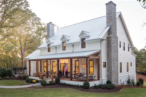 2 story off white house with porch with metal roofing|two story metal exterior home.